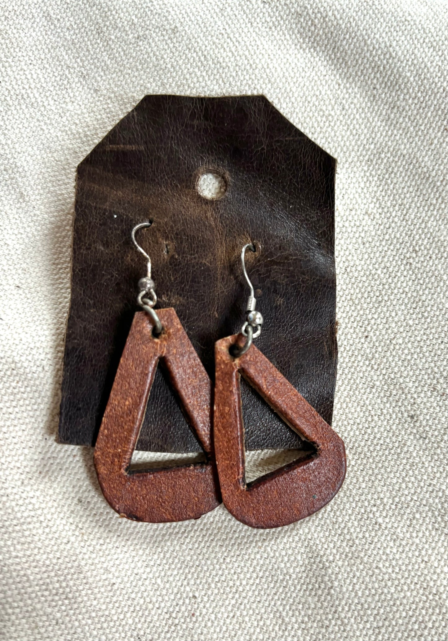 Handmade reclaimed distressed triangle leather earrings.