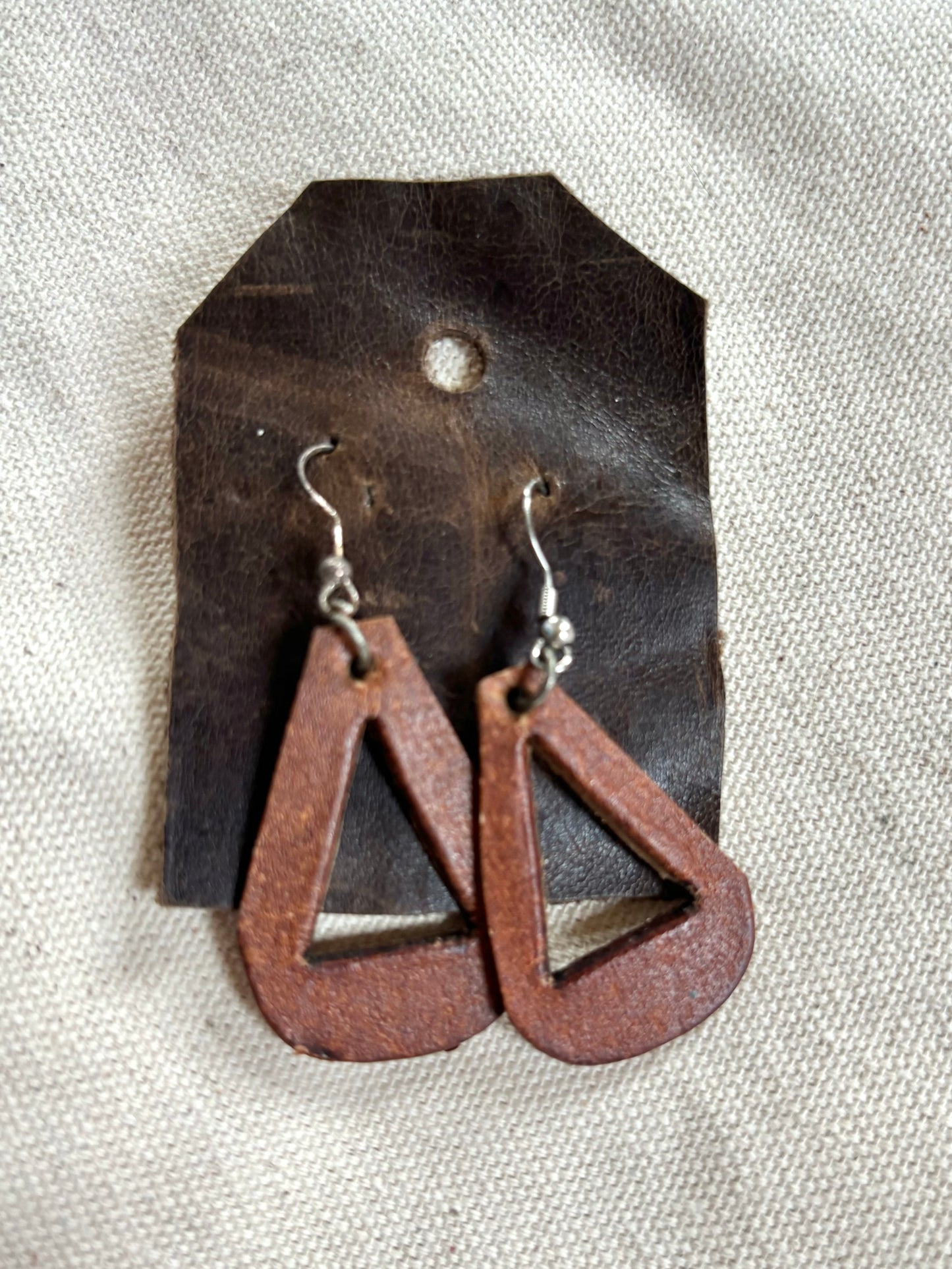 Handmade reclaimed distressed triangle leather earrings.