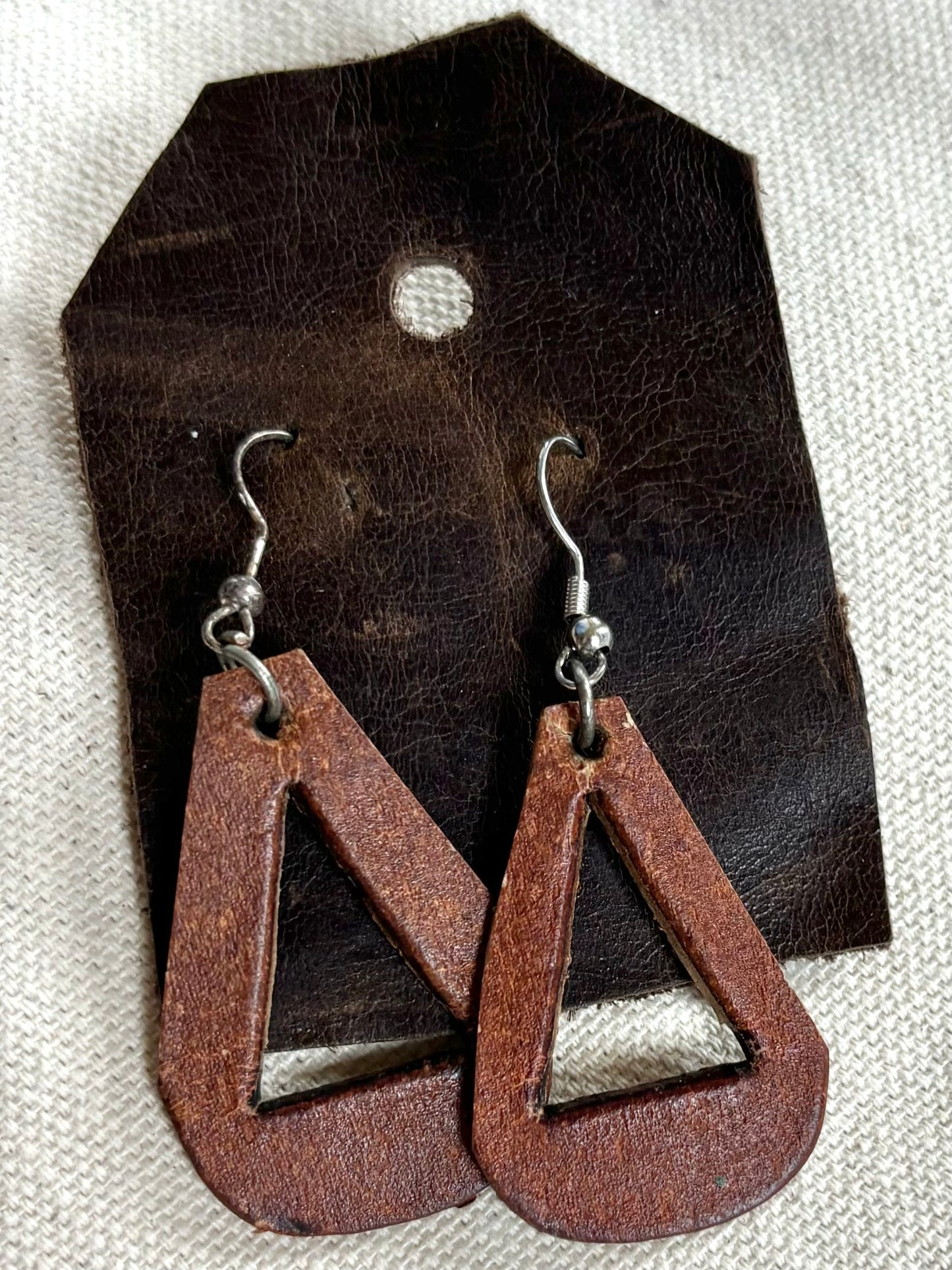 Handmade reclaimed distressed triangle leather earrings.